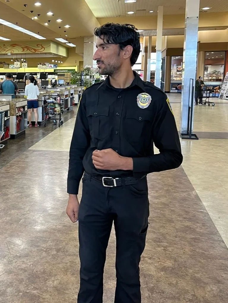 Security officer in uniform standing inside a mart