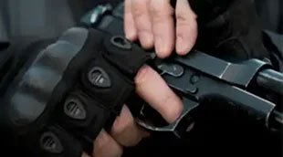 An armed guard holding a handgun