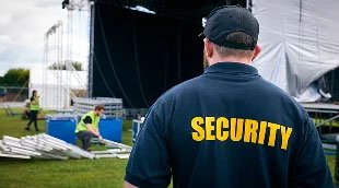 A security guard watching workers.