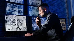 A security officer watching camera footage.